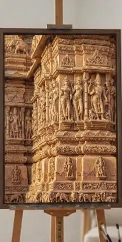 Oil painting of ornately carved sandstone temple walls covered in figures and deities.